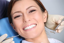 Lady admires her dental implant