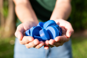 Close up of someone handing you a cluster of tasty bottle caps